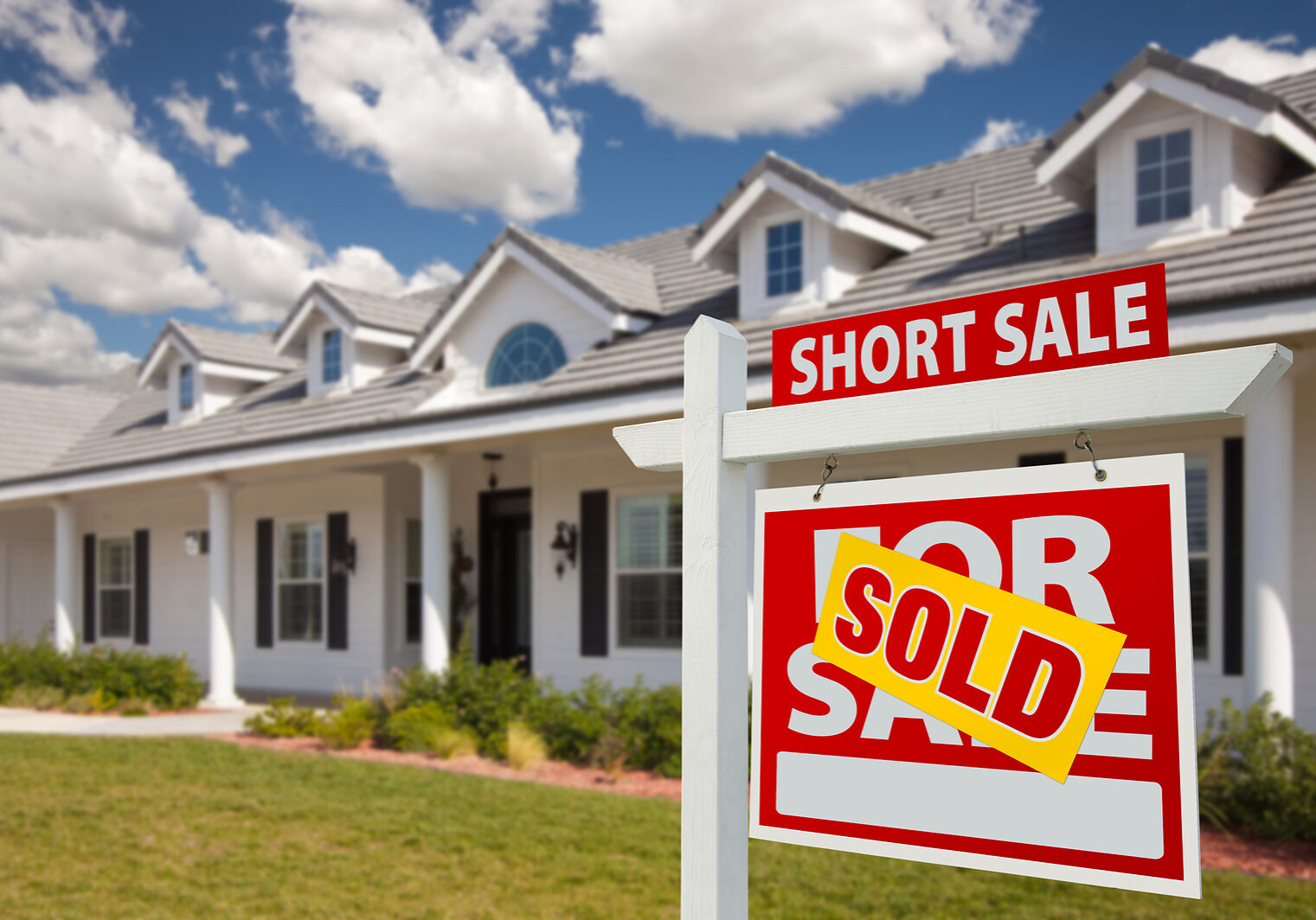 Sold Short Sale Real Estate Sign And House - Right Sold Short Sale Home For Sale Real Estate Sign in Front of New House - Right Facing.
